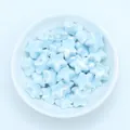 Macro detail of light blue pearlescent star ceramic beads for DIY jewelry making - Light Aqua Blue