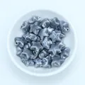 Macro detail of star-shaped ceramic beads with grey marble texture for jewelry DIY - Dark Gray