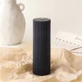 Vertical ribbed pillar soy candle in black finish on a vintage paper backdrop - 5*15cm / Black