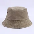 Detail view of khaki washed cotton bucket hat with tight stitching and metal air vents - Adjustable / Khaki