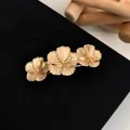 Elegant golden cherry blossom hair clip with three metallic flowers on black velvet - Golden Three Hibiscus Flower Spring Clip