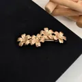 Elegant gold plated spring hair clip featuring four blooming flowers on a black background - Gold Five-Petal Flower