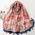 White floral Bali yarn scarf with red paisley print, blue edges and colorful tassels - Red Paisley (SL2606-012)