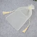 Off-white organza drawstring beach pouch with elegant tassel details and mesh texture - Organza Drawstring Bag / Cream White
