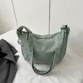 Mint green corduroy crescent crossbody bag with an adjustable strap and cute dog charm - Green