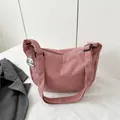 Pink corduroy crossbody dumpling bag with a cute white plush puppy charm decoration - Pink