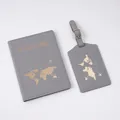 Close-up of dark grey passport holder and luggage tag set with gold map embossing - Luggage Tag / Gray