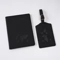 Detail of black leather passport cover and luggage tag with embossed world map and airplane - Black