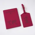 Close-up of burgundy world map embossed passport holder and matching luggage tag set - Rose Red