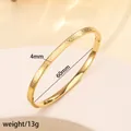 Macro detail of 4mm gold-plated titanium steel cuff featuring embossed Roman numerals - 38# 4mm Roman Numeral Polished Finish - Gold Sz645