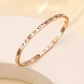 Close-up of rose gold titanium steel bangle with Roman numerals and inlaid zircons - 44# 4mm Hollowed-out Roman Rose Gold Sz651