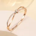 Detail of rose gold titanium bangle with crossover knot design and white pavé crystals - 61# Rose Gold Sz572