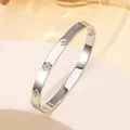 Detailed close-up of a silver titanium steel bangle with floral zircon stones and hinge - 69# Steel Color Sz612