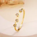 Macro shot of 18k gold plated titanium steel bangle featuring four heart-cut crystal stones - 76# White Sz086