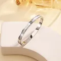 Close-up of polished titanium steel bracelet with shell inlay and zircon accents - 14# Steel Color Sz627