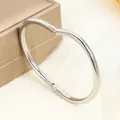 Polished silver stainless steel nail bangle with sparkling diamond accents on a jewelry box - 28# Nail - Steel Color Sz621