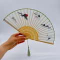 White silk folding fan with embroidered crane and sun motifs on a light wood frame - Folding Fan - Embroidery - Crane Bathed In Mountain Sunshine