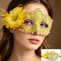 Detail of yellow lace masquerade mask with feathers, floral accents and pearl trim - Yellow
