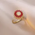 Macro shot of gold sunflower ring featuring red marquise stones and zircon center - J0803--6