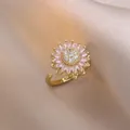Detailed view of rotating sunflower ring with pink crystal petals and pavé diamond center - J0803-2
