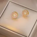 Macro shot of sunflower stud earrings featuring pink marquise crystals and tiny diamonds - E1304-2