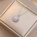 Detailed close-up of a rotating sunflower pendant with pink petals and inlaid diamonds - X4539-3