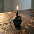 Creative black middle finger gesture scented candle burning on a rustic wood surface - Black
