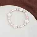 Pink and white handmade ceramic beaded flower bracelet with silver accents on a dish - 1750-01 Falling Cherry Blossoms