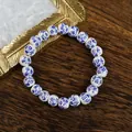 Blue and white porcelain bead bracelet with floral patterns on dark wood background - 1734-01 Blue and White Porcelain