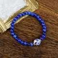 Deep blue beaded bracelet featuring a blue and white porcelain bead and golden spacers - 1734-03 Qinglan Crossing