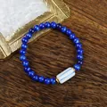 Deep blue cat eye beaded bracelet with white ceramic charm and golden spacers - 1734-04 Distant Mountain Indigo