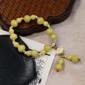 Pale green gourd ceramic bead bracelet with silver spacers and white flower tassel - Qing Can Gourd Style (1397-01)