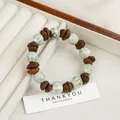 Ceramic bracelet with light green beads and brown coffee bean accents on white display - Green White Bean Style (1689-01)