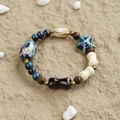 Ethnic style ceramic beaded bracelet featuring blue starfish and bone shaped charms - Sunny Conch Ethnic Bohemian Style (1752-01) / Black Blue
