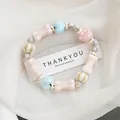 Pink and light blue ceramic beaded bracelet with bone and heart-shaped charms - Milk Candy Pudding Style (1732-01) / Multicolor