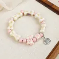 Handmade ceramic beaded bracelet with cream bone shapes and pink butterfly accents - Rich Fairy Style (1765-03) / Pink & Beige