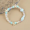 Blue ceramic beaded bracelet with white starfish, seashell, and fish charms - Spray Style (1756-03) / Light Blue