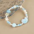 Light blue ceramic beaded bracelet with seashell and star charms for a summer ocean look - Shell Star Style (1756-04) / Light Blue