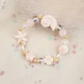 Pink ceramic beaded bracelet with conch and starfish charms on beige fabric background - Shell Style (1738-04) / Pink