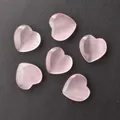 Set of six pink heart-shaped gemstones with cat-eye effect on a black background - Light Pink Cat Eye