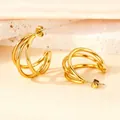 Three-layer gold hoop earrings with polished finish on a stone and silk background - Thin Round Wire Medium Size / Gold