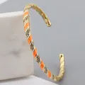 Adjustable gold plated cuff with orange and white enamel stripes and rhinestones - Orange