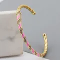 Adjustable gold-plated twisted bangle with pink white enamel stripes and sparkling zircons - Pink