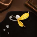 Golden leaf brooch with white pearl and pavé crystals on a luxury silk background - Yellow Leaf Pearl Brooch (XZ0351-2)