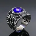 Detailed macro view of vintage titanium steel ring with hollow carving and blue gemstone - Steel Oiled Blue Gem
