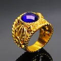 Macro view of vintage gold ring featuring deep blue oval gemstone and embossed patterns - Gold Plated Blue Zirconia