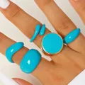 Detail shot of five turquoise blue enamel rings in various geometric shapes on hand - Lake Blue Drip Glaze Ring Set (7731)