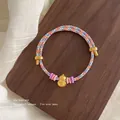 Handwoven multicolored rope bracelet featuring a golden gourd pendant and colorful beads - Multicolor Blue