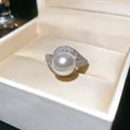 Macro detail of elegant pearl ring with zircon accents in a luxury white jewelry box - Real Gold Plated / Silver
