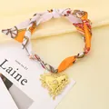 Choker in seta stampata vintage con un elegante ciondolo a cuore dorato strutturato - Arancione Viola